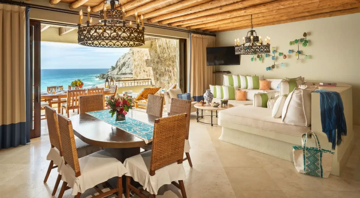 Open-concept villa with ocean-view patio, rustic beams, and colorful coastal decor.