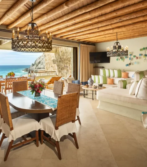 Open-concept villa with ocean-view patio, rustic beams, and colorful coastal decor.