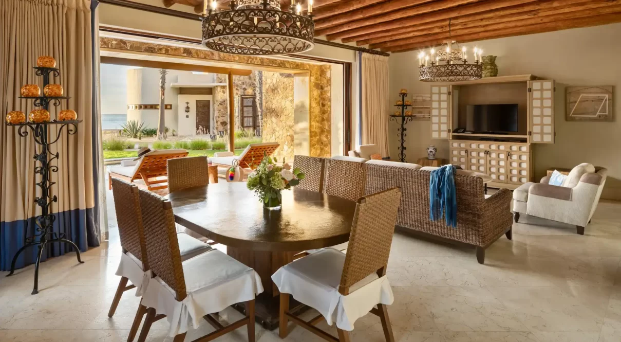 Elegant living and dining area with ocean-view patio at Waldorf Astoria Los Cabos Pedregal.